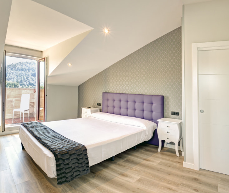 apartamentos la albarca hoznayo Estancia con cama doble y terraza exterior